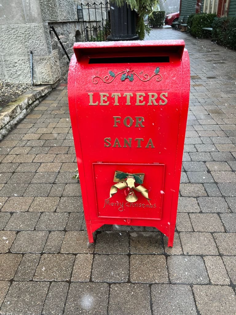 Red mailbox for Santa letters in snowy Niagara-on-the-Lake, perfect for holiday season vibes.