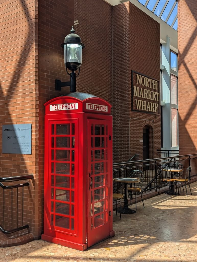 Vintage red telephone box inside North Market Wharf in New Brunswick, Canada.